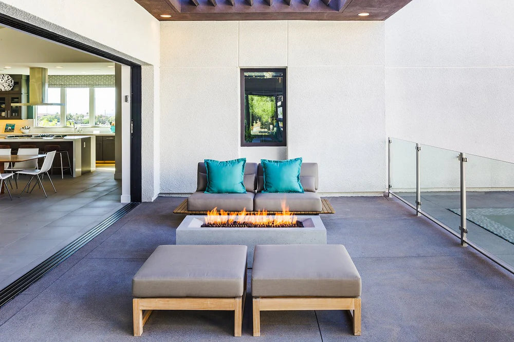 Modern patio with clean gas burning fire pit, stylish modern outdoor furniture and a multi-slide patio door.