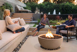 Family enjoying gas fire pit in backyard