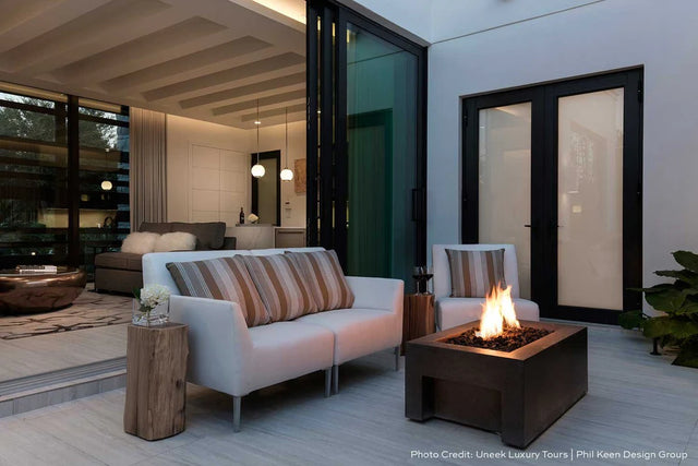 Stone patio with gas burning fire pit and modern stylish outdoor furniture