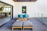 Modern patio with clean gas burning fire pit, stylish modern outdoor furniture and a multi-slide patio door.