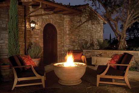 Night garden patio with lit gas burning fire pit and comfortable outdoor furniture